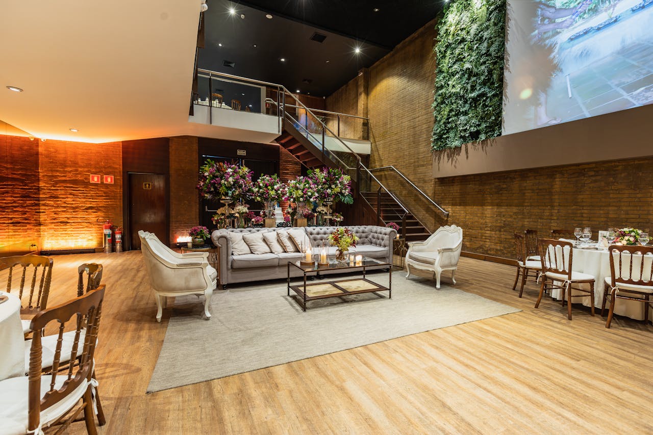 about-img Stylish indoor event space with modern furniture and floral arrangements, ideal for weddings and receptions.