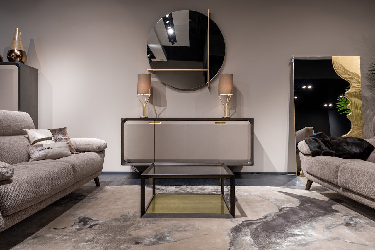 services-03 Stylish modern living room with elegant furniture, chic mirror, and warm lighting reflecting contemporary interior design.